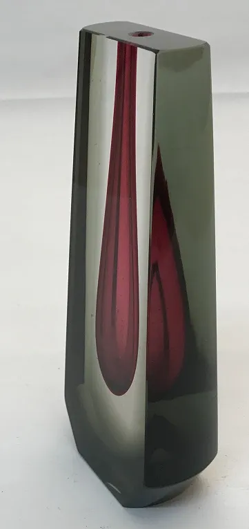 Antique Murano vase with geometric shapes, dark colors, in an elegant setting