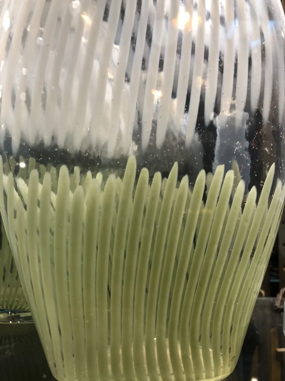 antique murano vase with decorative shape and light color at the top