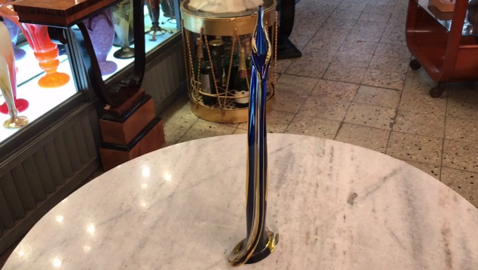 antique murano vase featuring elegant shape and vibrant colors, displayed in an antique gallery