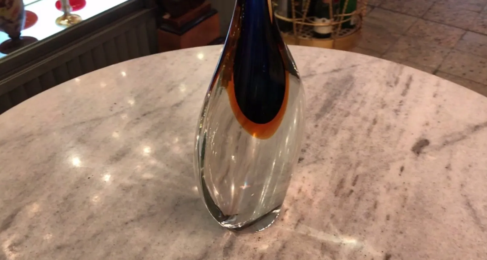 murano vase on a table, illuminated, with decorative details