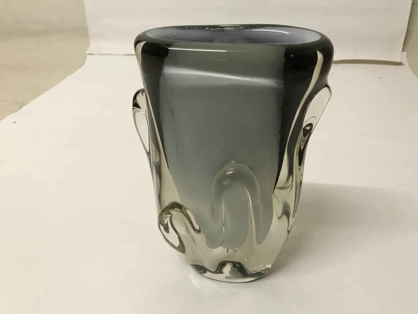 antique murano vase with stylized design and soft colors, in a well-lit room