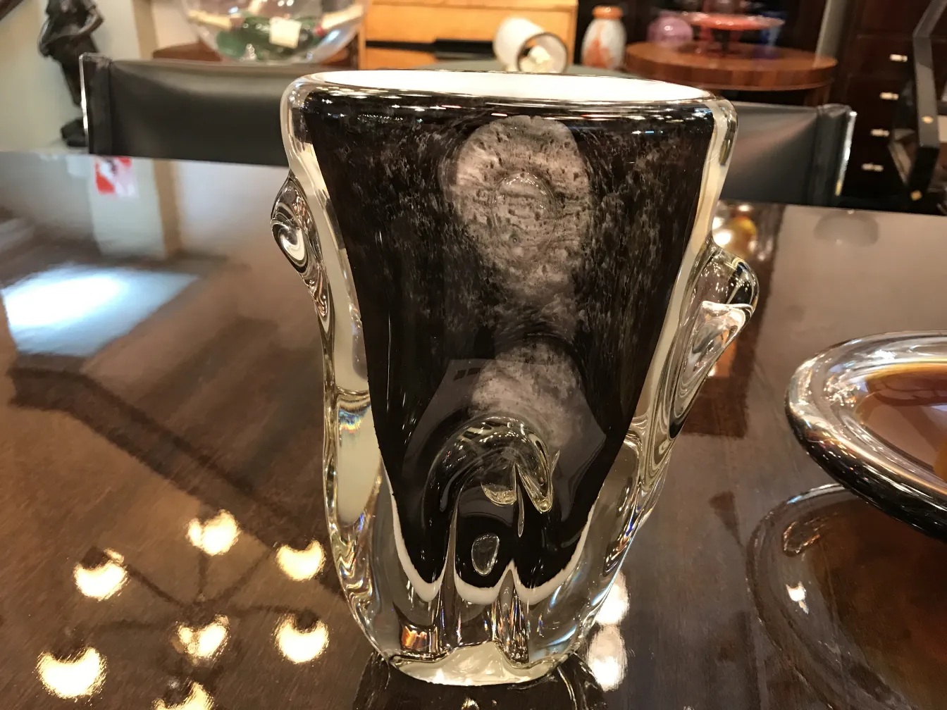 antique murano vase with unique shapes on a shiny table