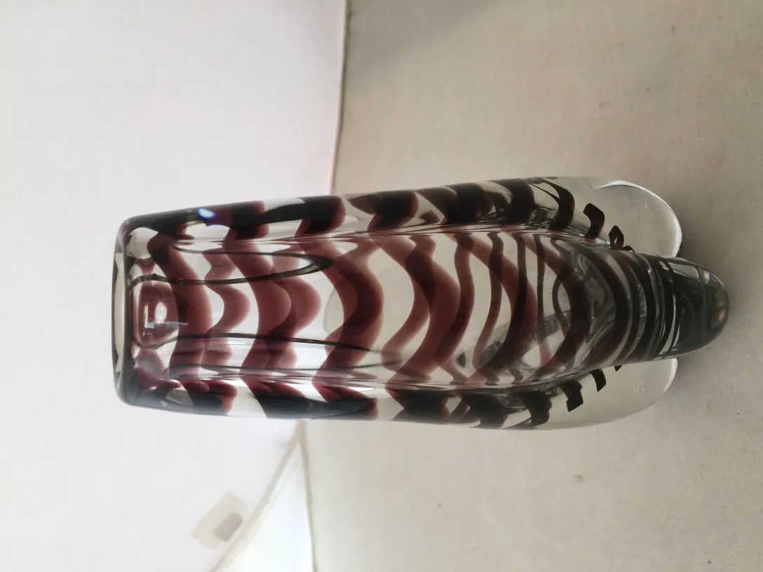 Antique Murano vase with decorative color patterns, neutral background.