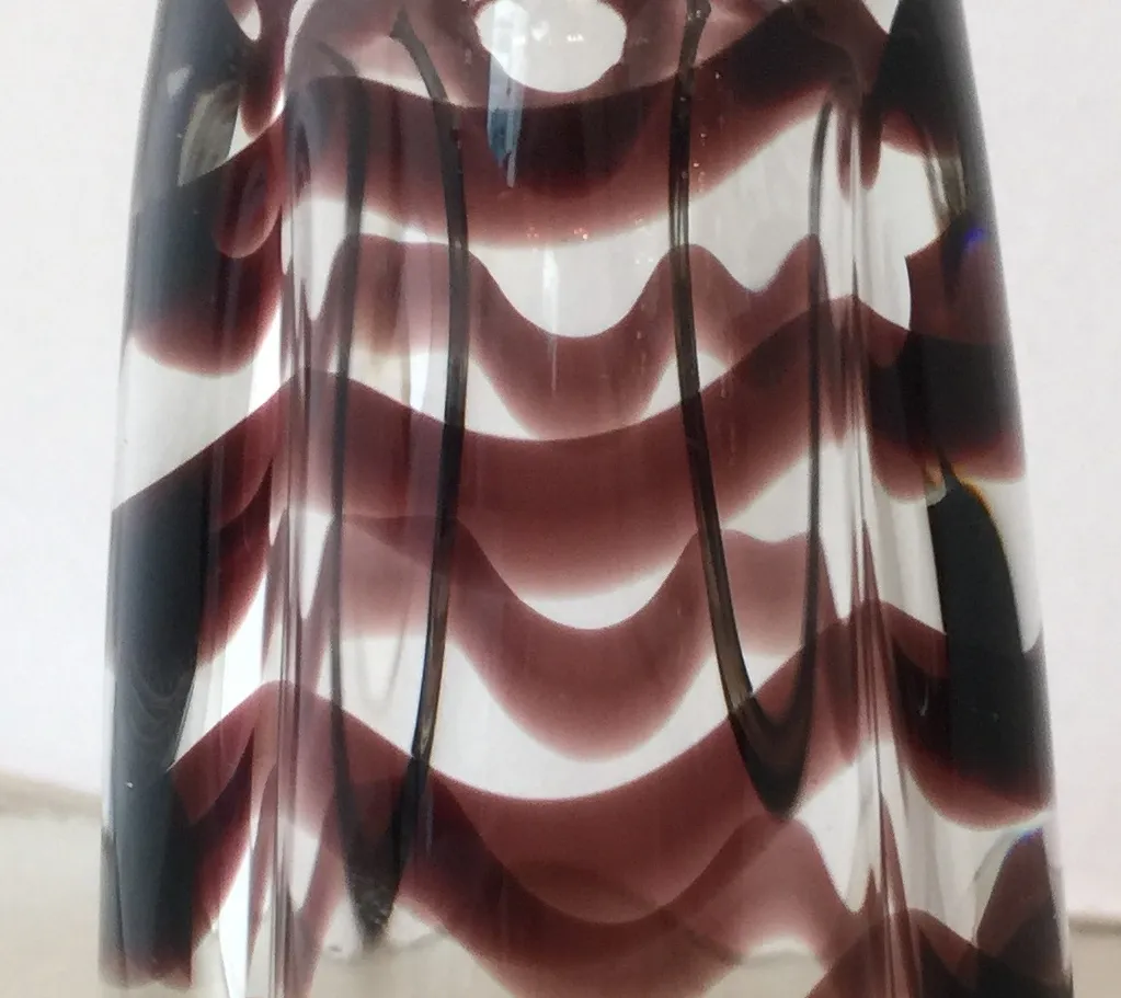 murano vase featuring warm color wavy pattern