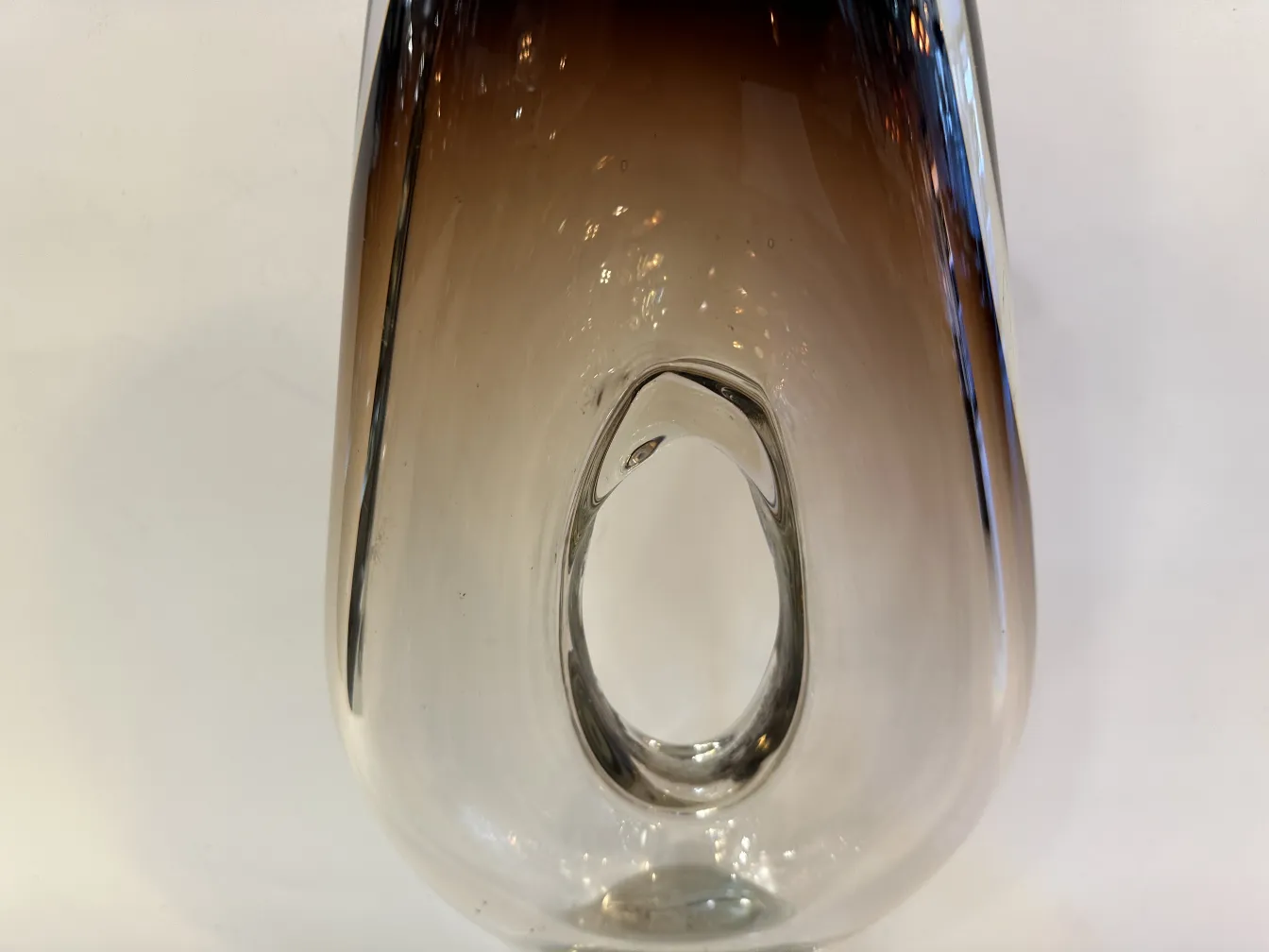 distinctive and elegant shaped murano vase, colorful, in a classic setting