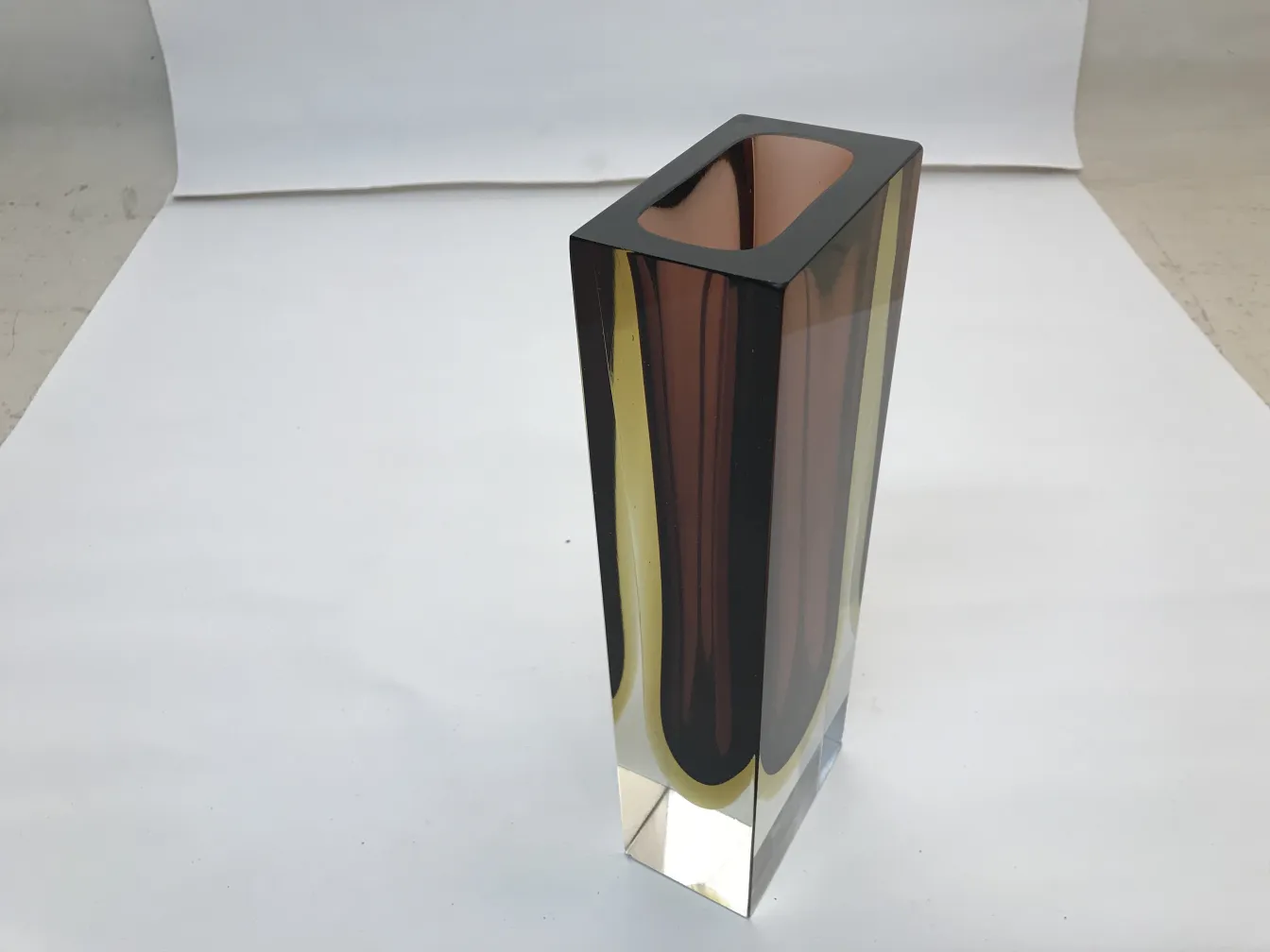 antique murano vase with rectangular design and warm colors, on white background.