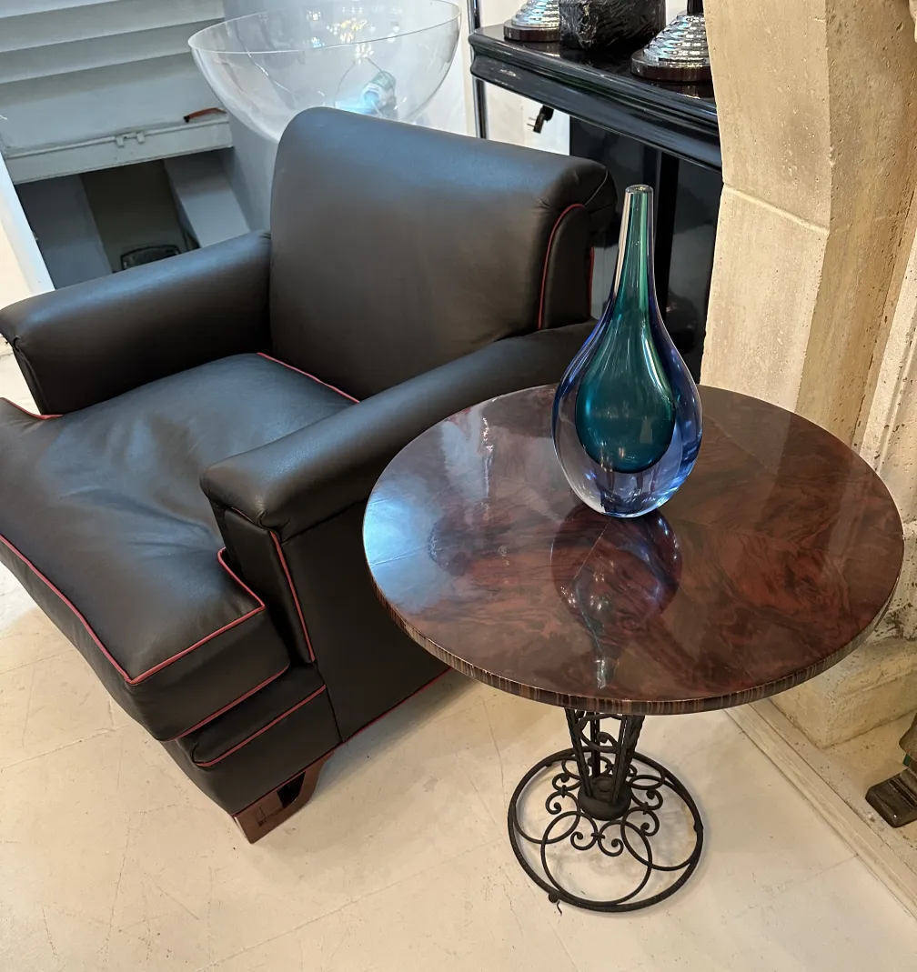 antique murano vase on wooden table with leather chair