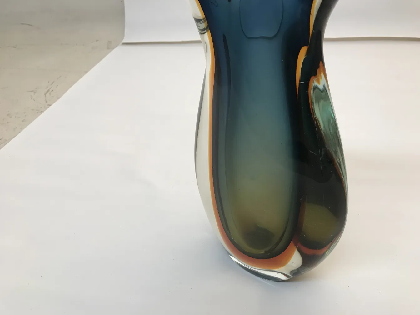 antique murano vase in dark tones with curved design