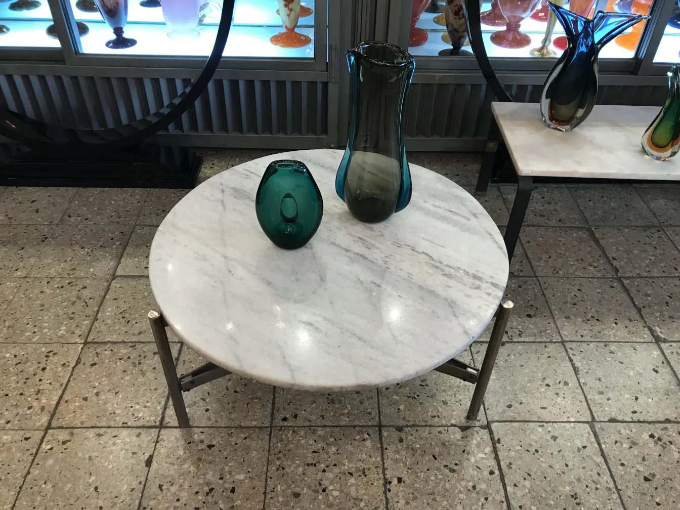 antique murano vase in blue and green tones on marble table