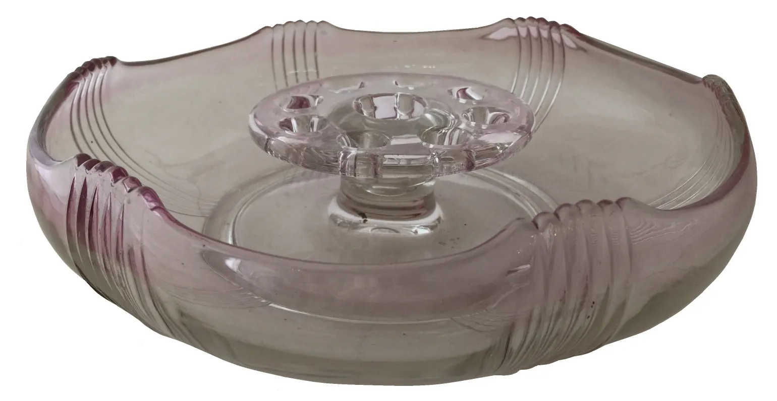 Antique Murano vase, light pink, wavy shape, in an elegant setting.