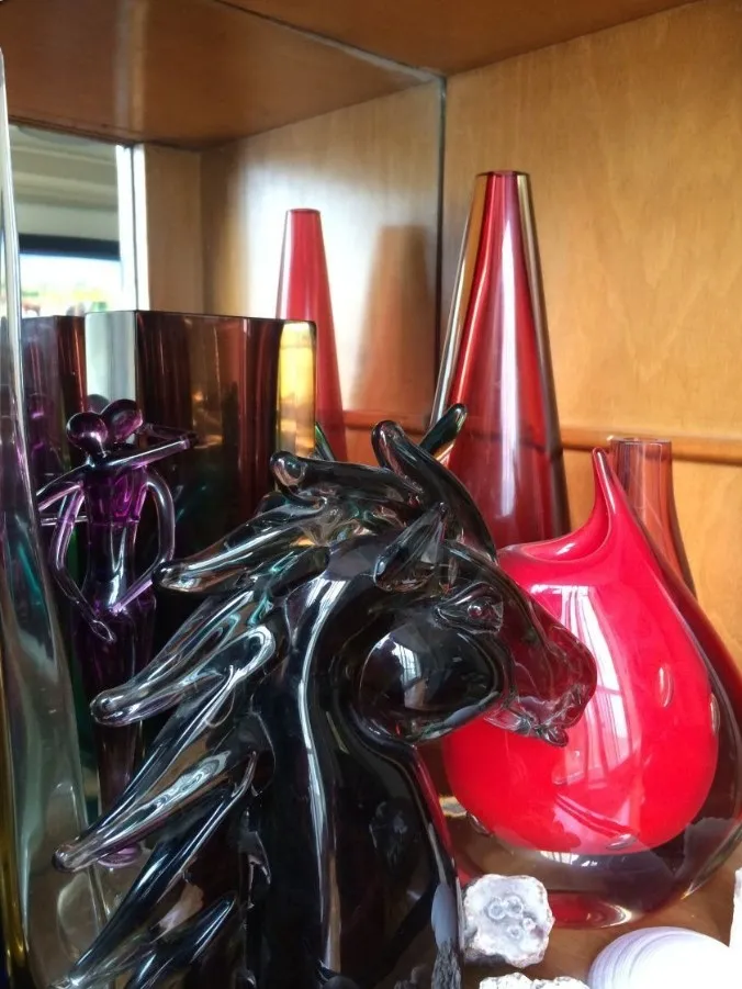 antique murano sculpture shaped like a black horse with colorful vases