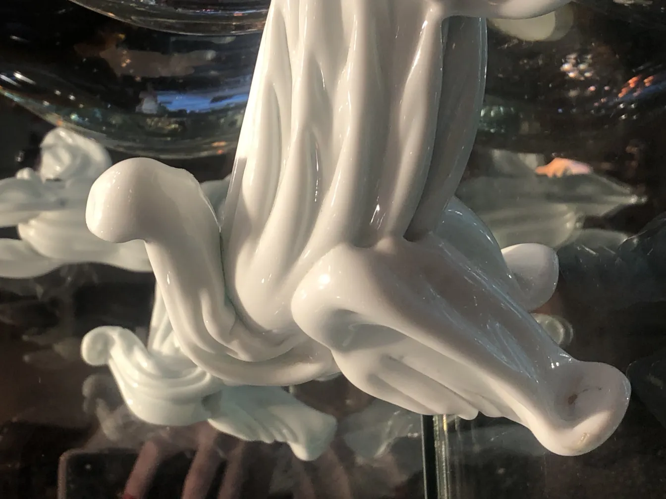 antique murano sculpture with elegant flowing design, set in an antique environment