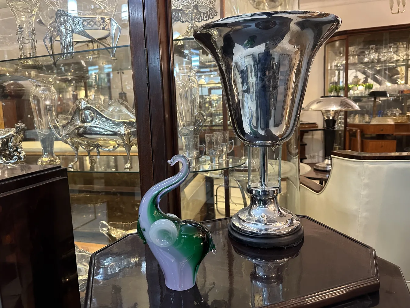 Antique Murano sculpture with vibrant colors and elegant design, decorative in an antique setting.