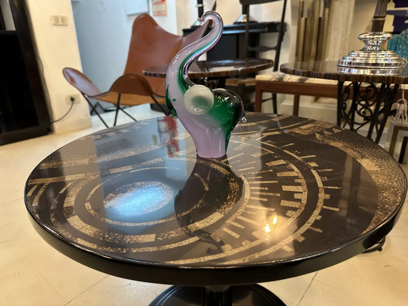 Murano sculpture on decorative table, green and pink colors.
