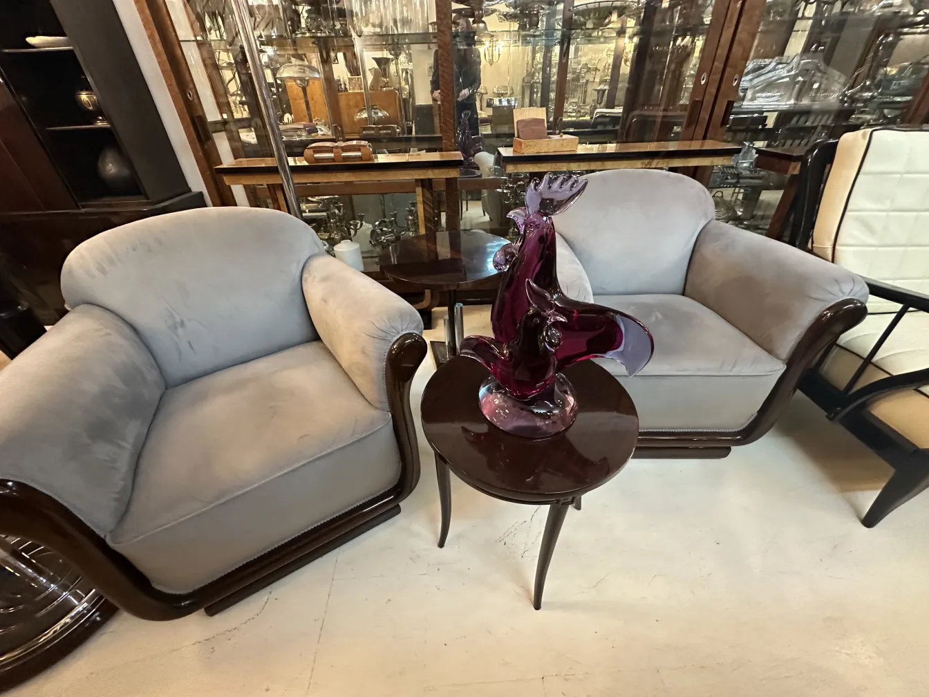 purple murano sculpture on a table in antique setting