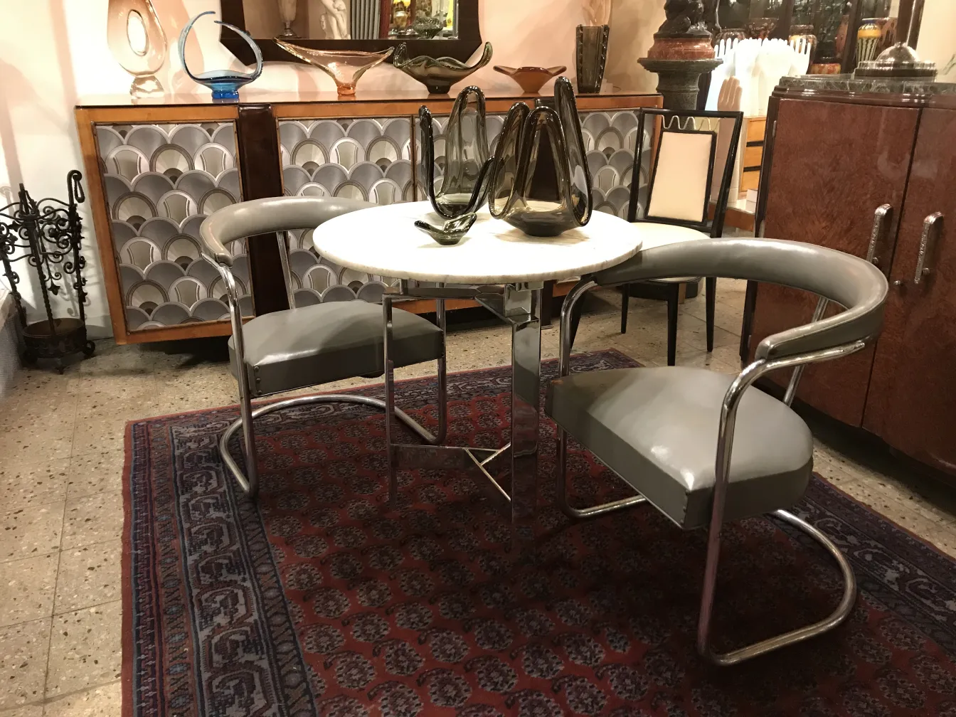 antique murano glass on decorative table with contemporary chairs