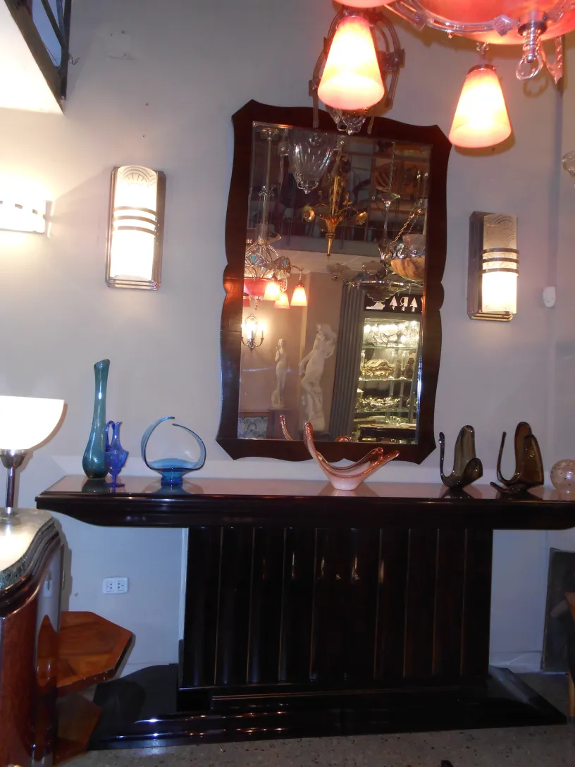 antique decorative piece made of Murano glass with elegant shapes and vibrant colors, surrounded by other decorative items