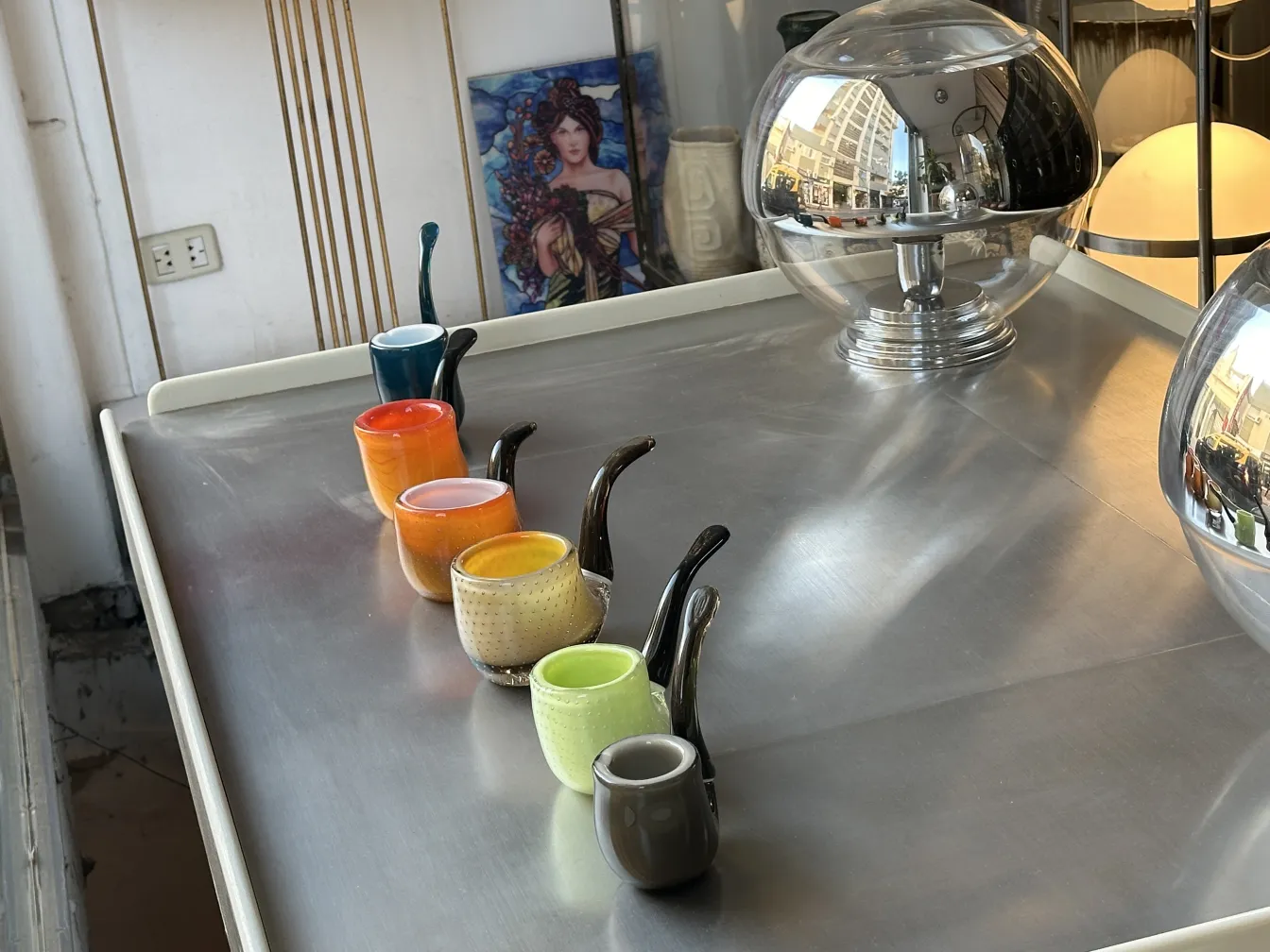 variety of murano glass cups in bright colors on a table