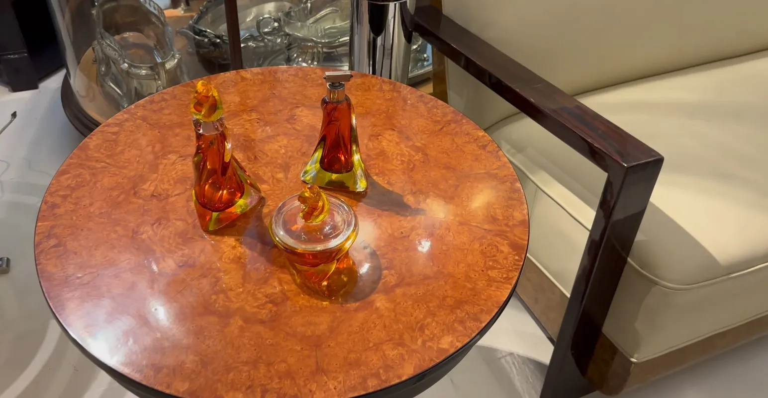 three decorative murano glass bottles on a table