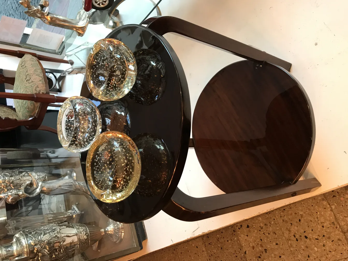 three murano glass bowls on a black table
