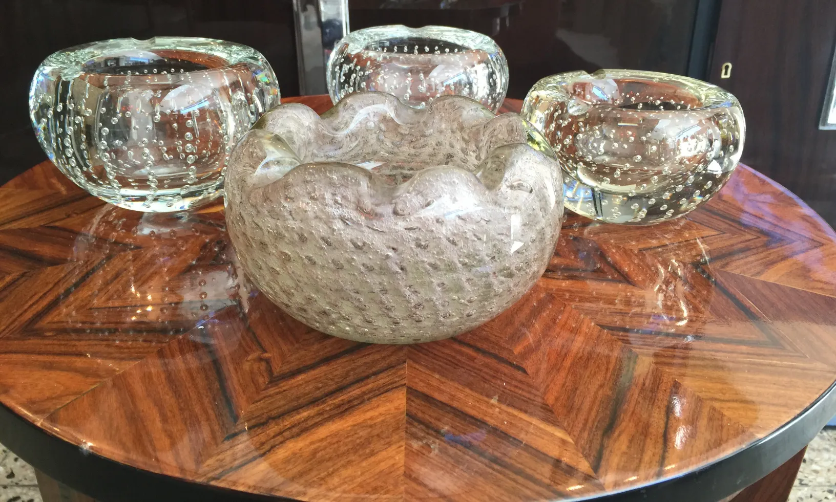 Murano glass bowl in various colors on wooden table