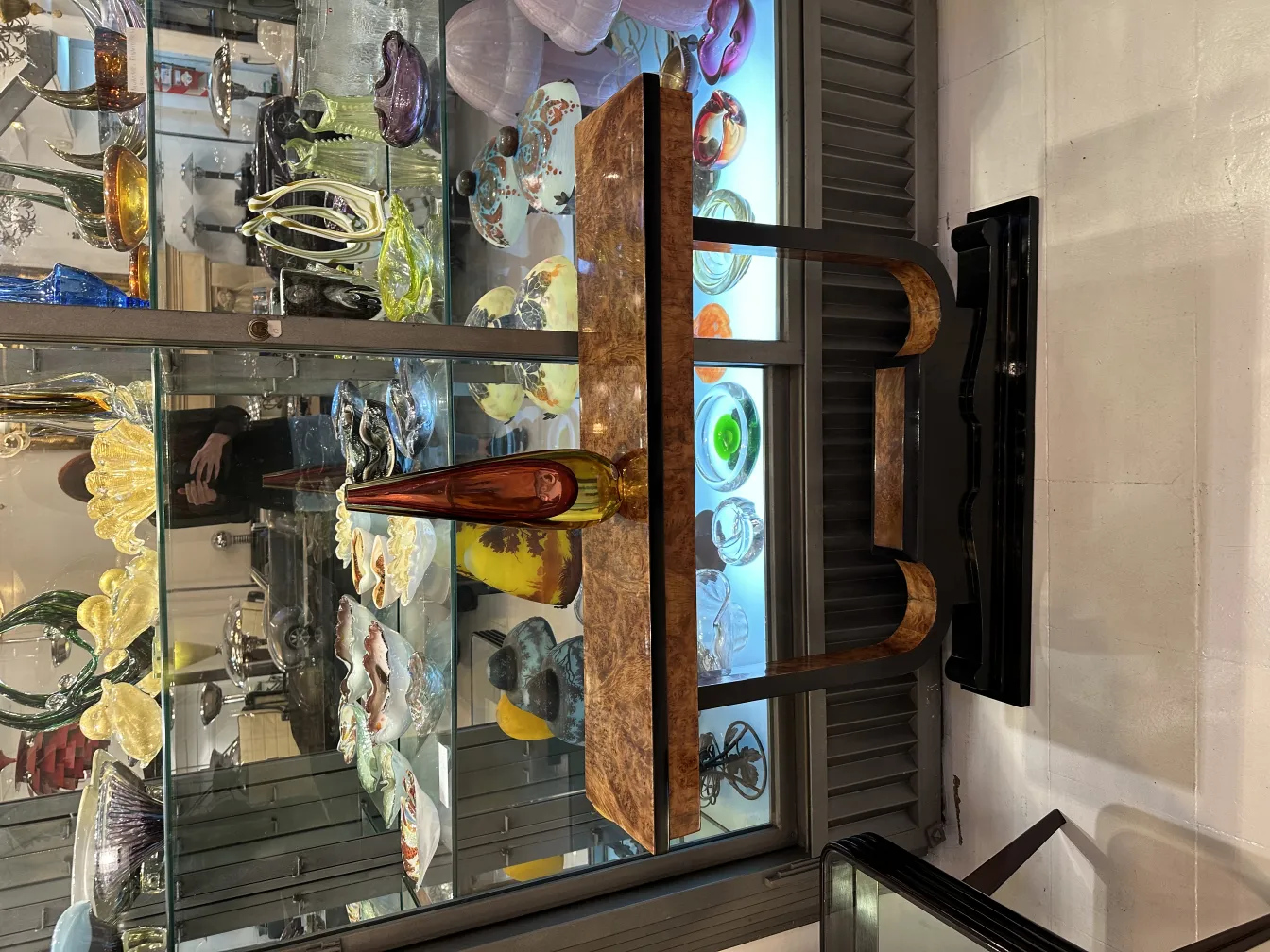 antique murano glass bottle with warm tones on a shelf