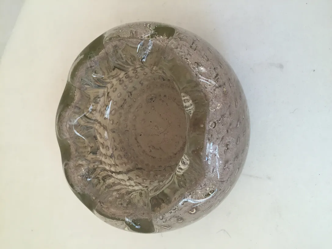 Antique Murano glass with light tones and wavy shapes, decorative.