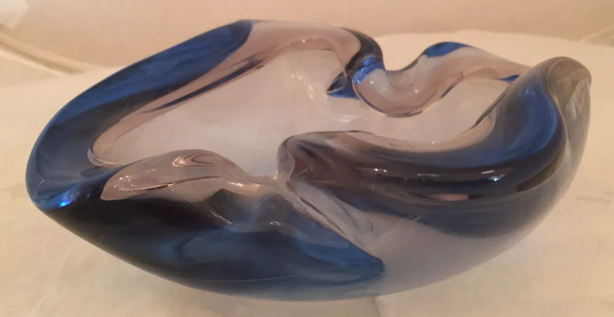 beautiful murano glass with dark and light blue details in an organic shape