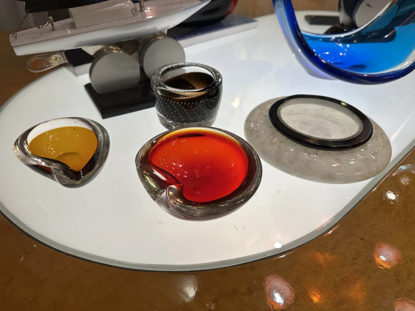four pieces of antique murano glass in various shapes and colors on a table