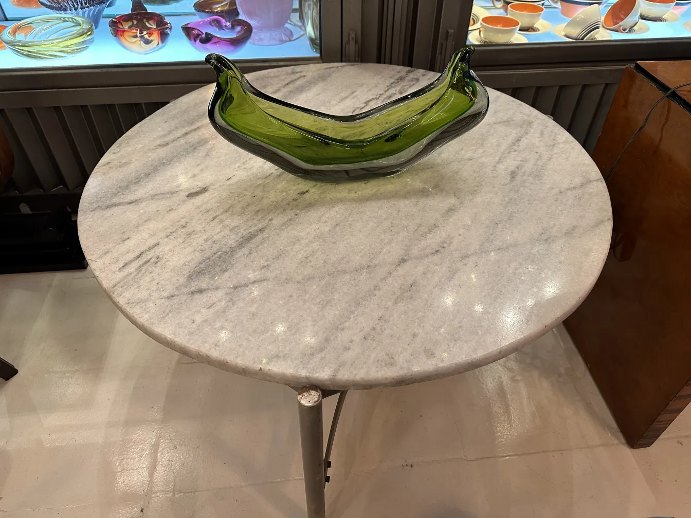 green murano glass bowl on marble table