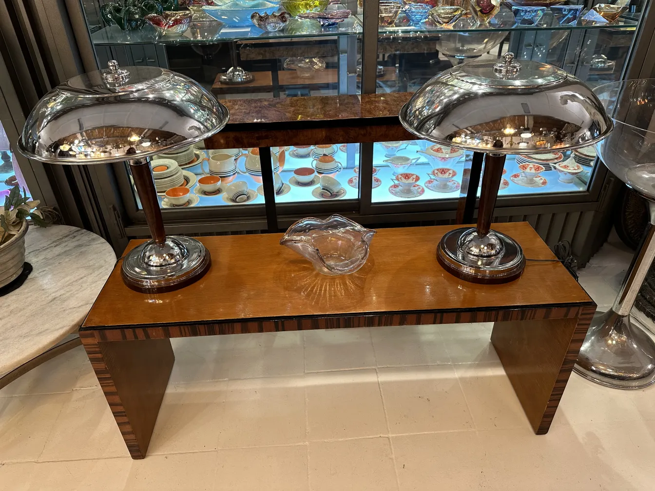 table with antiques and murano glass lamps