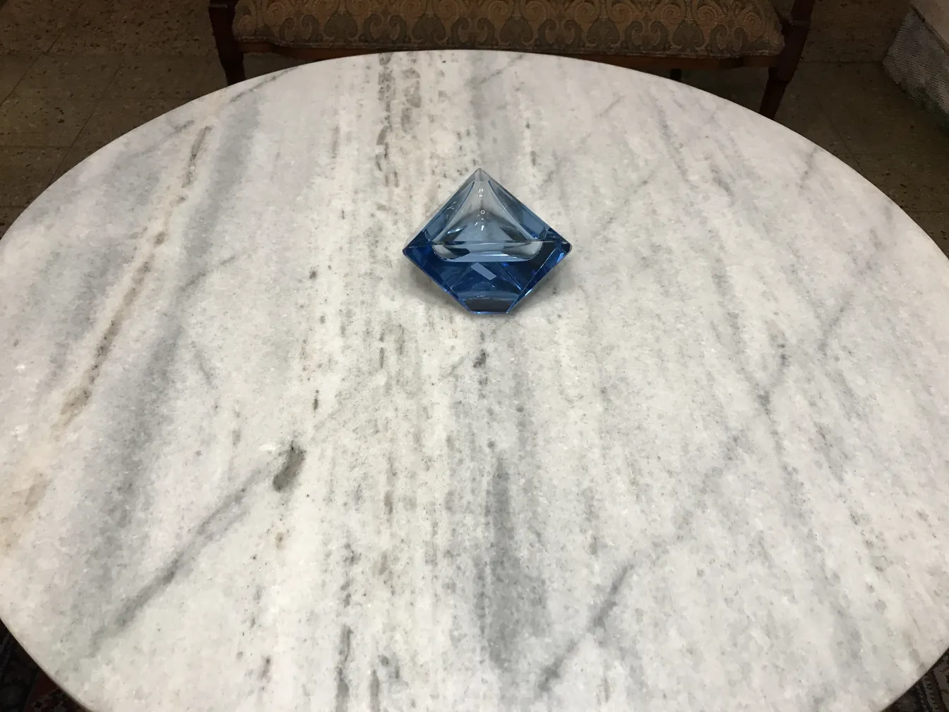 Decorative blue pyramid-shaped Murano glass on table