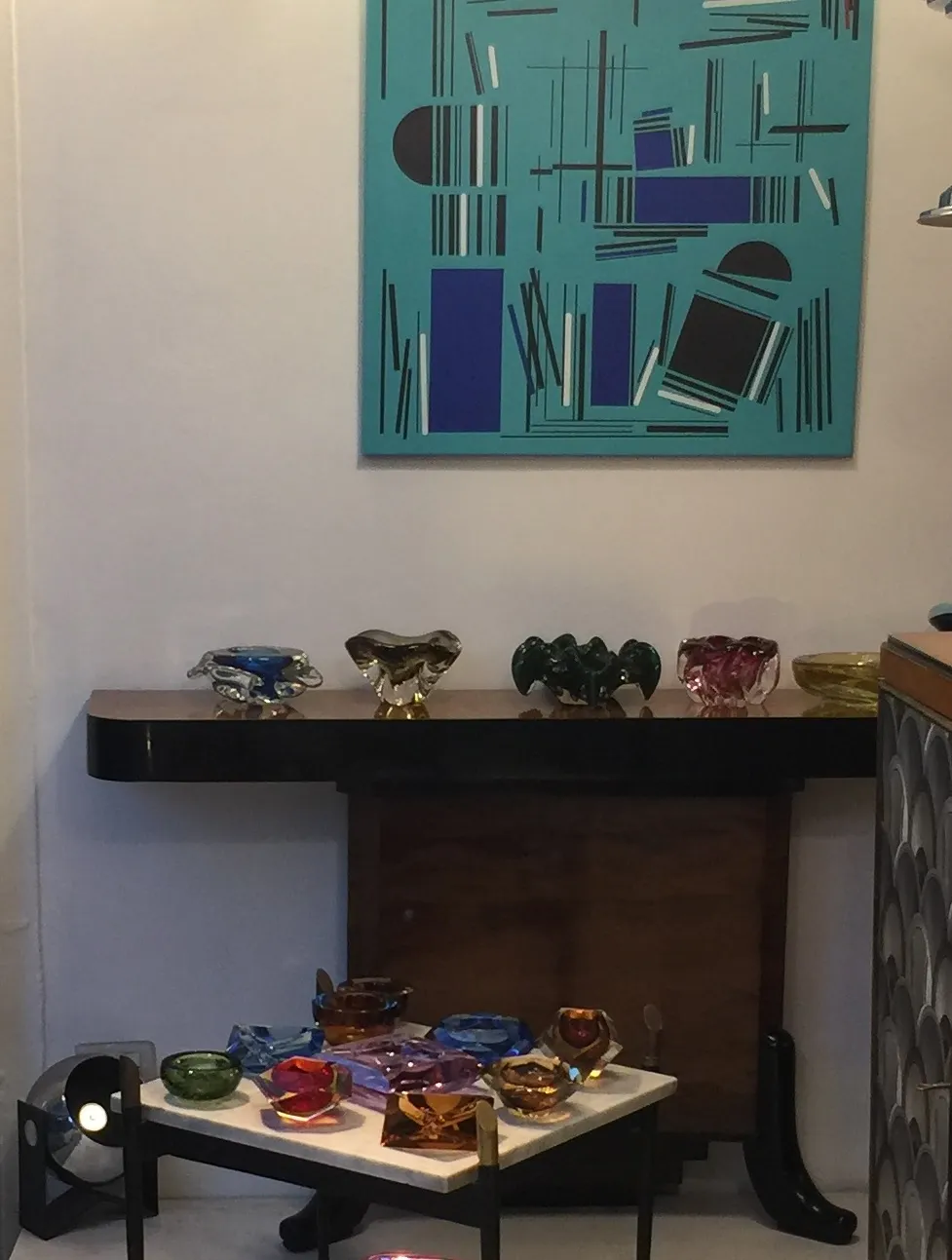 Decorative murano glass pieces in various colors on a table.