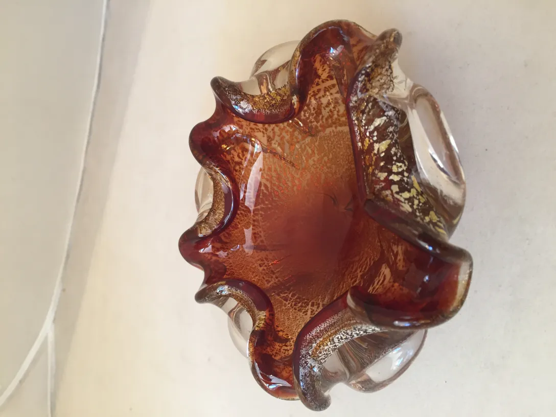 decorative antique murano glass with wavy design and warm colors.