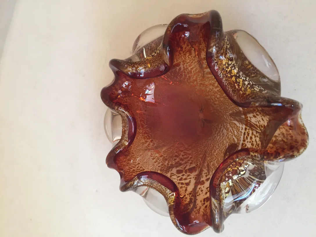 antique murano glass piece with wavy shape in warm tones