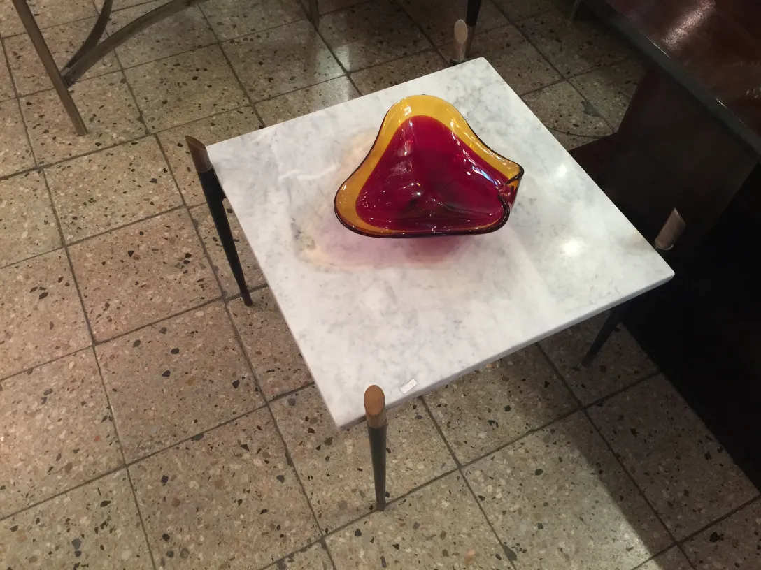 murano glass bowl in red and yellow on a white table