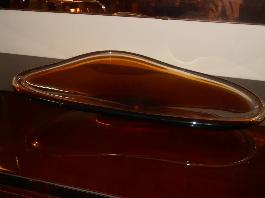 decorative antique murano glass in amber tone with smooth curves
