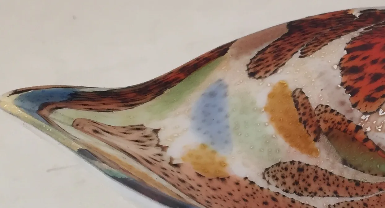 Murano glass featuring colorful decorative patterns in earthy tones