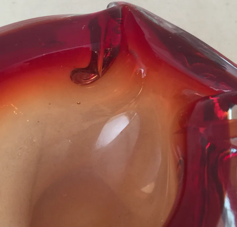 Antique Murano glass sculpture in shades of red and orange.