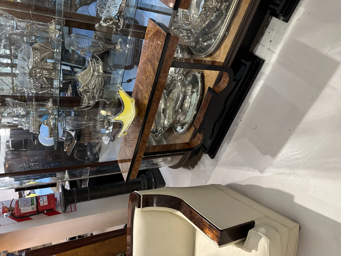 Antique Murano glass with vibrant colors in display case.