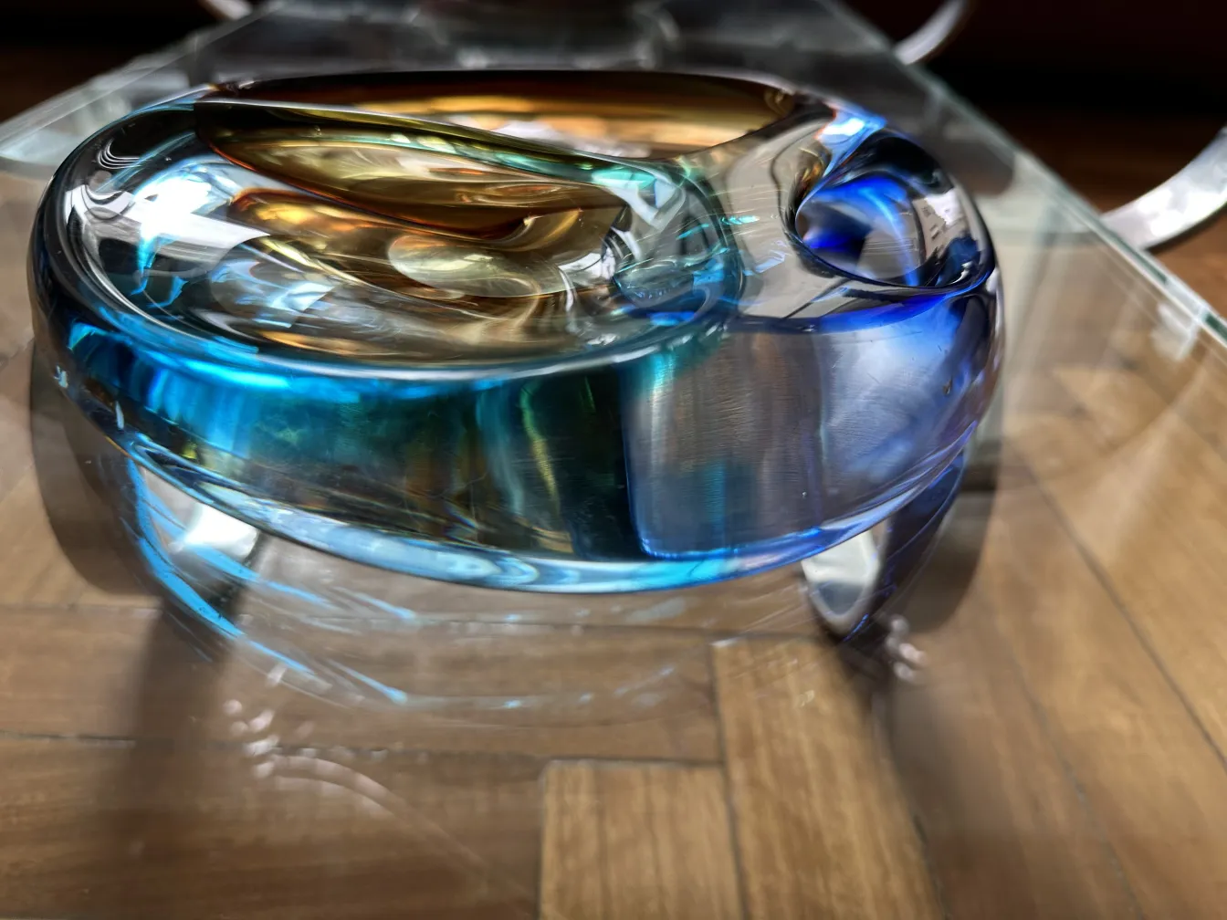 Murano glass in wavy shape with blue and golden tones.