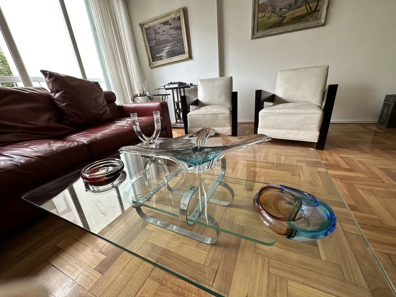 antique murano glass with fluid shapes on glass table