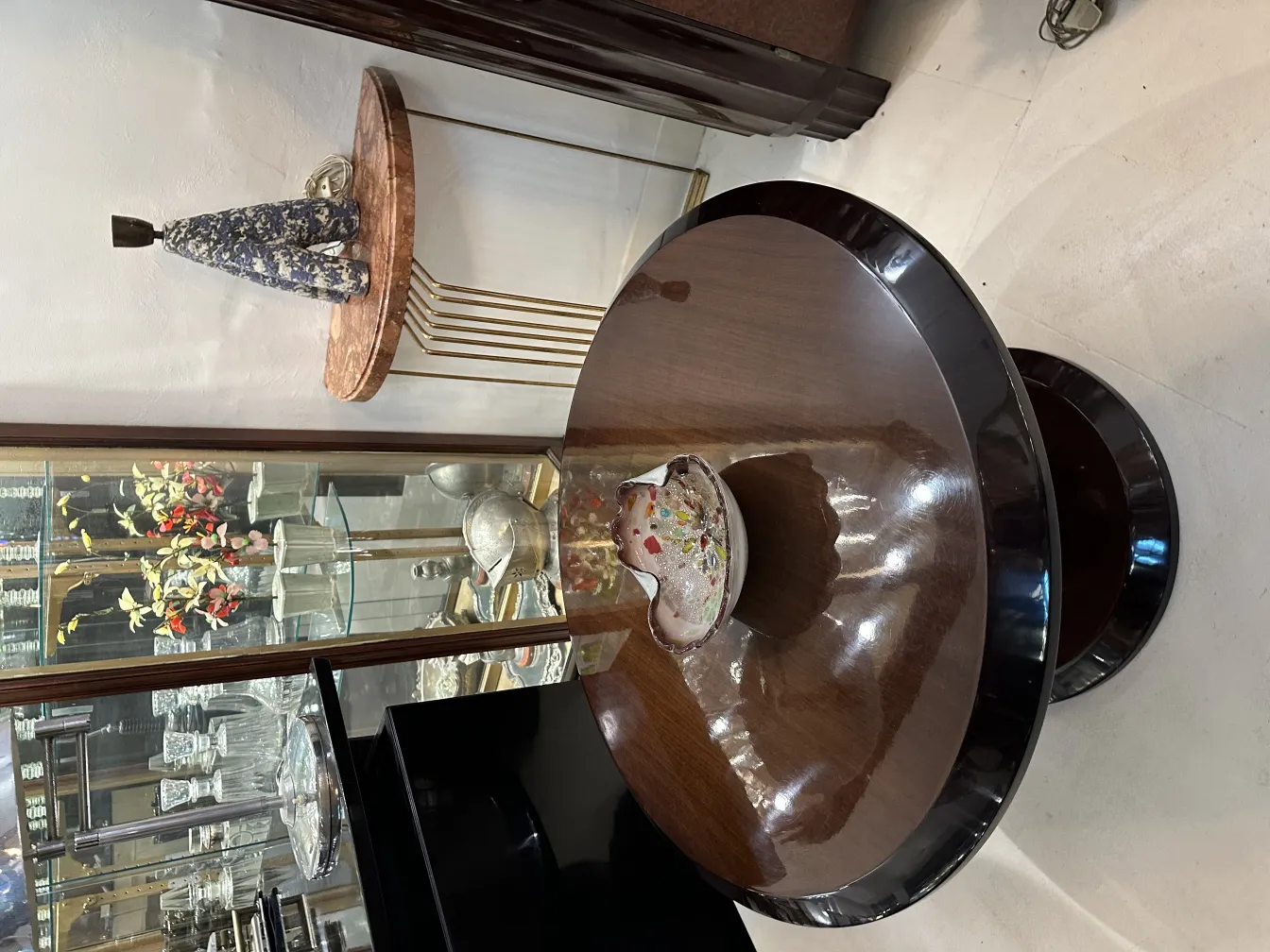 antique murano glass bowl with vibrant colors on a shiny table