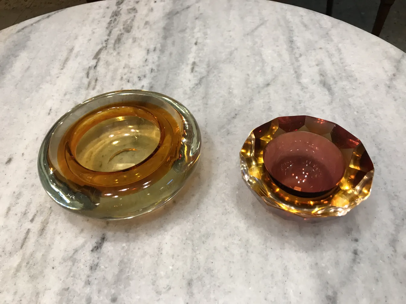 two antique murano glass pieces on a marble table
