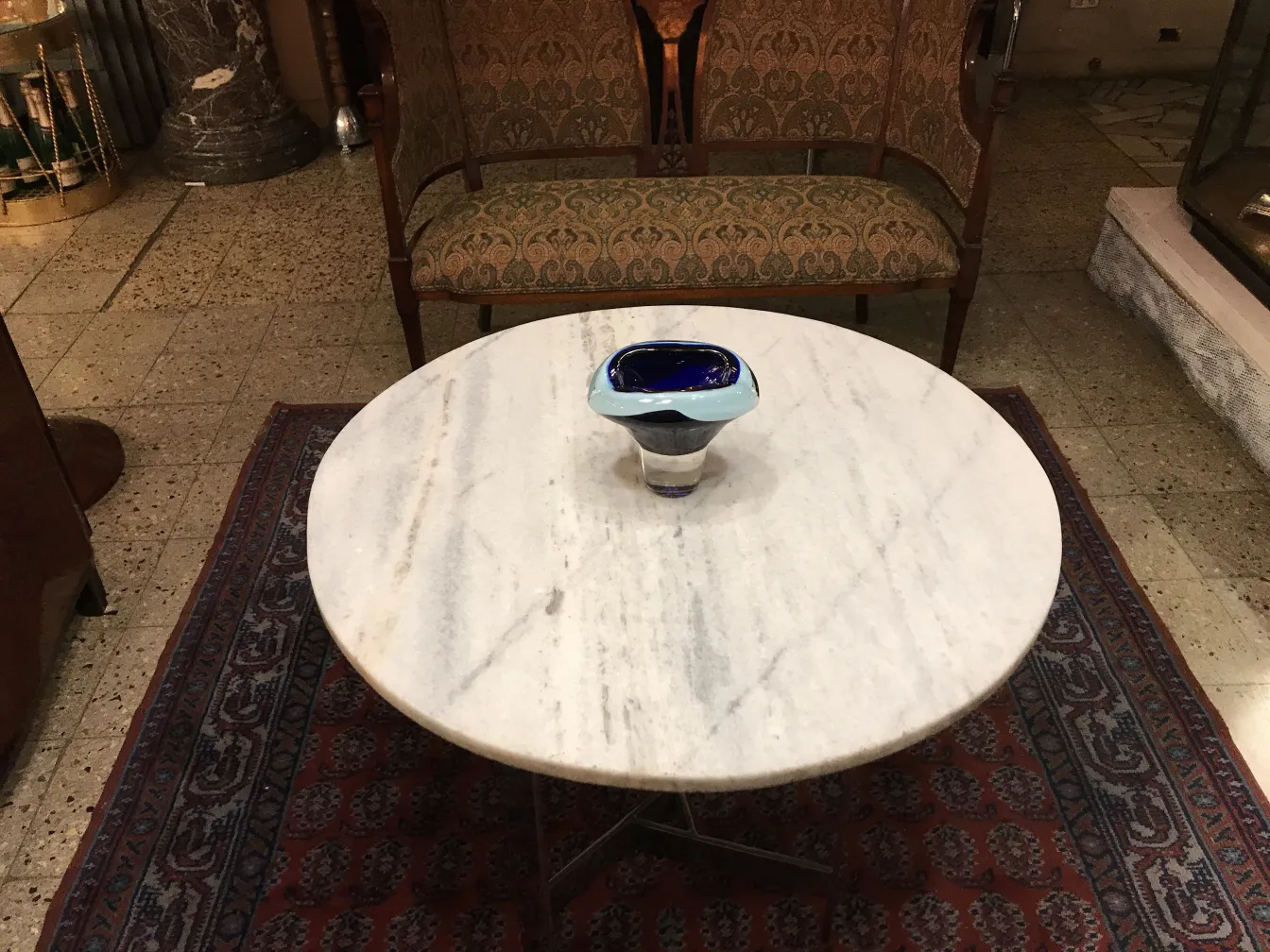 decorative murano glass piece with blue and black design on a table