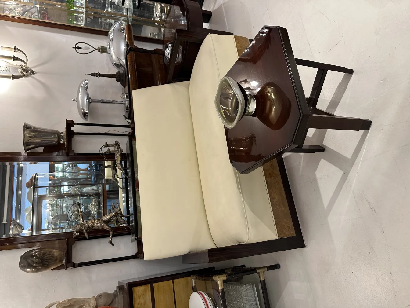 white chair next to hexagonal table and murano glass