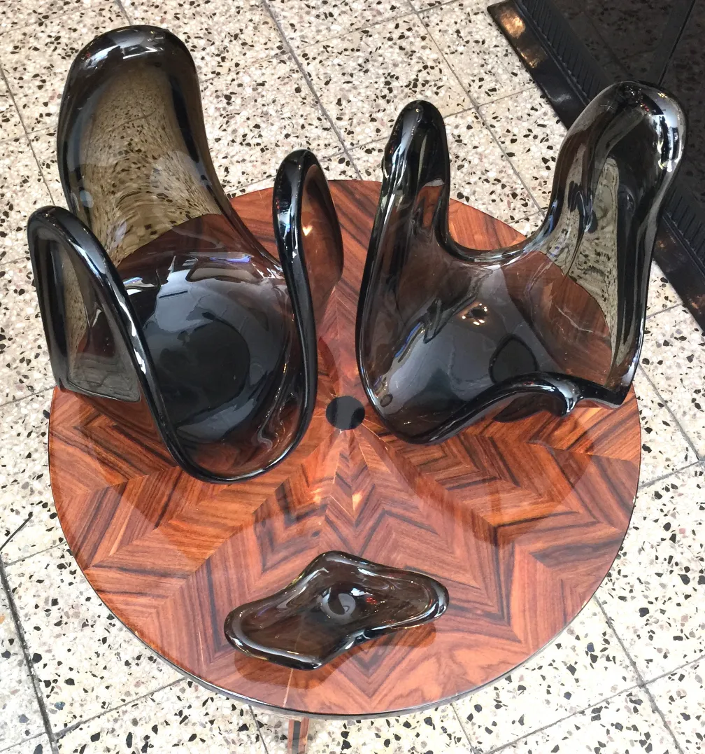 three antique murano glass pieces on a decorative table