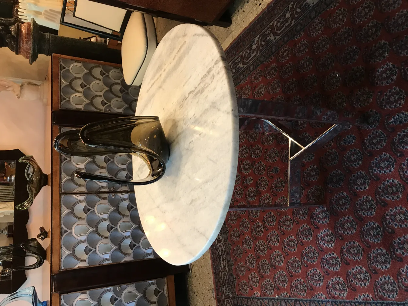 dark murano glass vase on round marble table