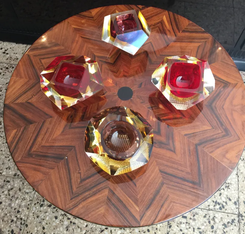 three octagonal pieces of murano glass on a table