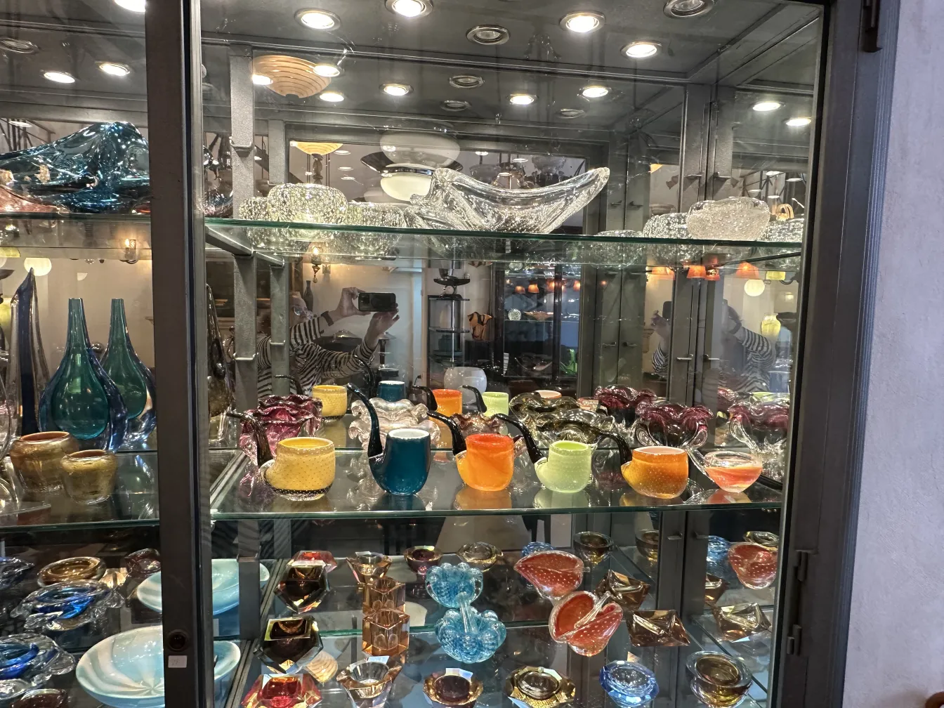 Display of antique Murano glass with various colors and shapes